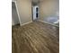 Large bedroom with wood-look floors and neutral walls at 4315 Berkley Dr, Tampa, FL 33610