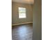Bright bedroom with wood-look floors and large window at 4315 Berkley Dr, Tampa, FL 33610