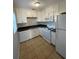 Updated kitchen featuring white cabinets and appliances at 4315 Berkley Dr, Tampa, FL 33610
