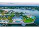Aerial view of waterfront property with pool and dock at sunset at 5033 W San Miguel St, Tampa, FL 33629