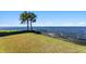 Landscaped backyard with waterfront access and palm trees at 5033 W San Miguel St, Tampa, FL 33629