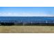 Breathtaking view of the water with a black fence and lush green grass at 5033 W San Miguel St, Tampa, FL 33629