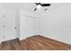 Bedroom with wood-look floors, ceiling fan, and white closet doors at 5472 Cactus Cir, Spring Hill, FL 34606