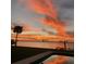 Stunning sunset view over the water from the backyard, complete with a pool at 560 Riviera Dr, Tampa, FL 33606