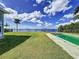 Backyard oasis featuring a pool, lush lawn, and waterfront views at 560 Riviera Dr, Tampa, FL 33606