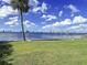Scenic waterfront property with a grassy yard, boat lift, and city views at 560 Riviera Dr, Tampa, FL 33606