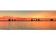 Breathtaking sunset over the water, cityscape in the distance at 560 Riviera Dr, Tampa, FL 33606