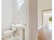 Powder room featuring a pedestal sink, toilet, and neutral wall paint at 6922 Hawthorne Trace Ln, Riverview, FL 33578