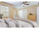 Comfortable staged bedroom featuring neutral colors, a ceiling fan, and ample closet space for storage at 6922 Hawthorne Trace Ln, Riverview, FL 33578