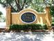 A sign for St. Charles Place Townhomes stands amidst manicured landscaping at 6922 Hawthorne Trace Ln, Riverview, FL 33578