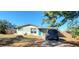 Ranch style home with teal front door and car parked on driveway at 7045 Lenox Dr, New Port Richey, FL 34653