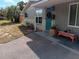Front view of a charming house with teal door and walkway at 7045 Lenox Dr, New Port Richey, FL 34653