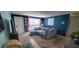 Cozy living room with sectional sofa, blue walls, and tiled floors at 7045 Lenox Dr, New Port Richey, FL 34653