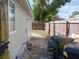Side yard with brick path and trash cans at 7045 Lenox Dr, New Port Richey, FL 34653