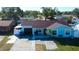 Cute light blue house with brown roof, white fence, and driveway at 8240 Greenleaf Cir, Tampa, FL 33615