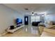 Living room with tile floors, white couches and a large TV at 8240 Greenleaf Cir, Tampa, FL 33615