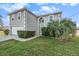 Two-story house with gray exterior, landscaping, and a driveway at 8388 Maltby Rd, Spring Hill, FL 34606