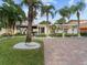 Beachfront home with palm trees and brick driveway at 843 Eldorado Ave, Clearwater Beach, FL 33767