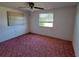 Spacious bedroom with carpet and a large window at 1147 Viking Dr, Holiday, FL 34691