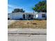 Ranch-style home with a single-car garage and mature landscaping at 1147 Viking Dr, Holiday, FL 34691