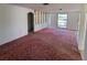 Large living room featuring tiled and carpeted floors at 1147 Viking Dr, Holiday, FL 34691