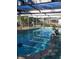 Kidney shaped swimming pool with a screened enclosure at 1147 Viking Dr, Holiday, FL 34691