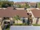 Aerial view of condo complex with multiple brown roofed buildings and mature landscaping at 13608 S Village Dr # 6105, Tampa, FL 33618
