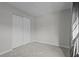 An empty bedroom with light grey carpeting and a large closet at 13608 S Village Dr # 6105, Tampa, FL 33618
