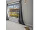 Bedroom with grey curtains, a modern lamp, and a large window displaying the exterior scenery at 13608 S Village Dr # 6105, Tampa, FL 33618