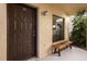 Close up of the unit's front door and window with outdoor seating at 13608 S Village Dr # 6105, Tampa, FL 33618