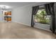 Spacious living room featuring hardwood floors and a large window with natural light at 13608 S Village Dr # 6105, Tampa, FL 33618