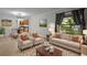 Inviting living room space with plenty of natural light and views into the kitchen at 13608 S Village Dr # 6105, Tampa, FL 33618