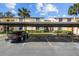 Covered parking area with several parking spots and a car at 13608 S Village Dr # 6105, Tampa, FL 33618