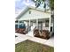 Newly renovated home with a light green exterior, modern railings, and neatly landscaped front at 4125 W Arch St, Tampa, FL 33607