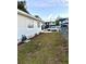 Side yard with landscaping and a hose reel at 4125 W Arch St, Tampa, FL 33607