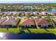 Aerial view of lakefront homes with lush landscaping at 4845 Marble Springs Cir, Wimauma, FL 33598