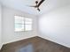 Bright bedroom with hardwood floors and a ceiling fan at 4845 Marble Springs Cir, Wimauma, FL 33598