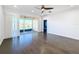 Gathering room with hardwood floors, sliding doors to patio, and water view at 4845 Marble Springs Cir, Wimauma, FL 33598