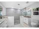 Modern bathroom with a large walk-in shower, double vanity, and pebble floor at 747 Brightwaters Ne Blvd, St Petersburg, FL 33704