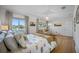 Serene bedroom with a large bed and sitting area, hardwood floors and water views at 747 Brightwaters Ne Blvd, St Petersburg, FL 33704