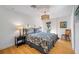 Main bedroom with a king-size bed, hardwood floors, and private balcony access at 747 Brightwaters Ne Blvd, St Petersburg, FL 33704
