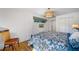 Main bedroom with a king-size bed, hardwood floors and views of tropical landscape at 747 Brightwaters Ne Blvd, St Petersburg, FL 33704
