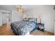 Main bedroom with king bed, hardwood floors, and access to bathroom at 747 Brightwaters Ne Blvd, St Petersburg, FL 33704