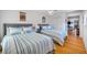 Bedroom with two twin beds, hardwood floors and view into adjacent living space at 747 Brightwaters Ne Blvd, St Petersburg, FL 33704