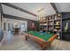 Game room with pool table, built-in shelving, and high ceilings at 747 Brightwaters Ne Blvd, St Petersburg, FL 33704