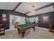 Game room with pool table, built-in shelving, and high ceilings at 747 Brightwaters Ne Blvd, St Petersburg, FL 33704