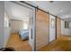 Hallway with light wood floors and barn doors at 747 Brightwaters Ne Blvd, St Petersburg, FL 33704