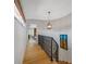 Light-filled hallway with wood floors, leading to bedrooms and staircase at 747 Brightwaters Ne Blvd, St Petersburg, FL 33704