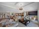 Spacious living room with high ceilings, a large TV, and built-in shelving at 747 Brightwaters Ne Blvd, St Petersburg, FL 33704