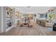 Living room with built-in shelving, hardwood floors, and a wet bar at 747 Brightwaters Ne Blvd, St Petersburg, FL 33704